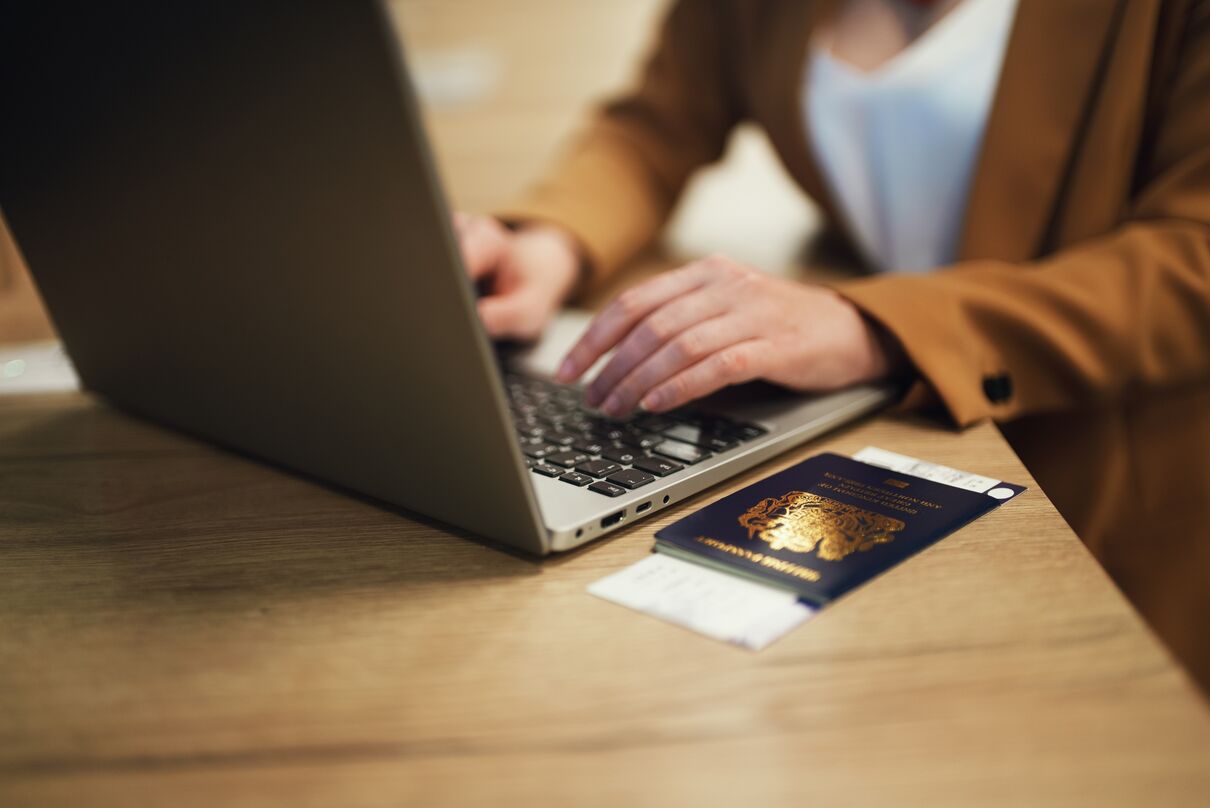 Women with a laptop and her passport 